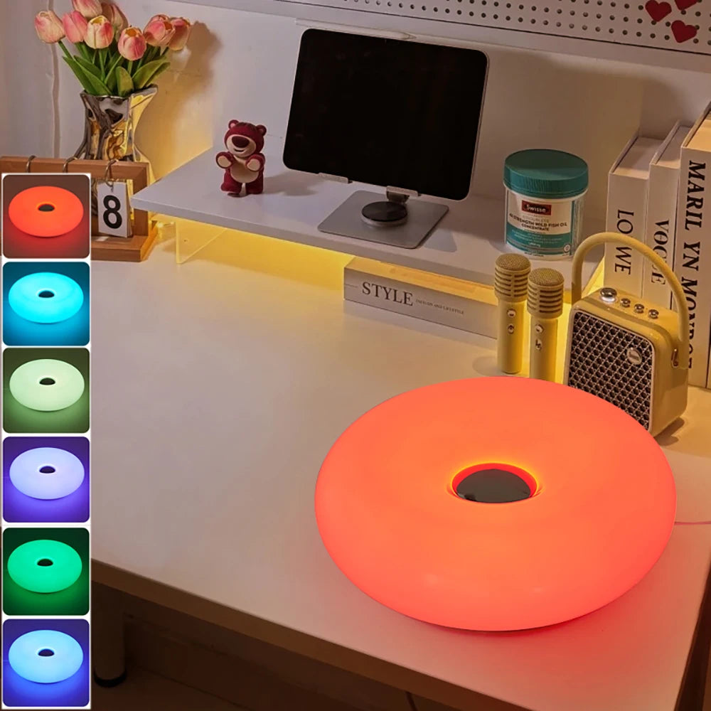 Color-changing LED mood lamp on modern desk with decor and tablet setup